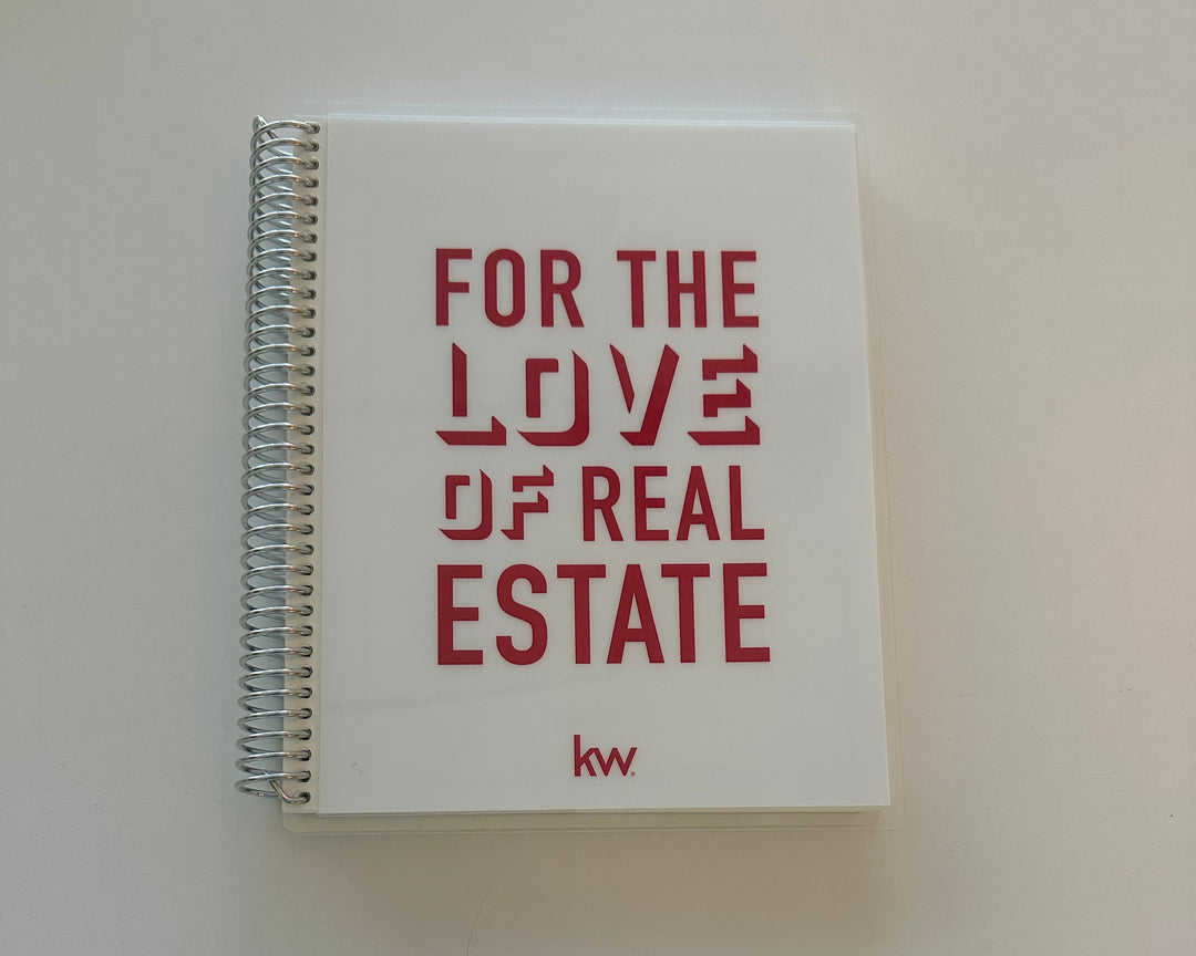 Notebook with 'For the Love of Real Estate' text on a plain background