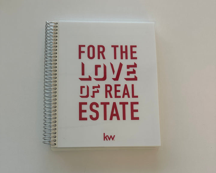 Notebook with 'For the Love of Real Estate' text on a plain background