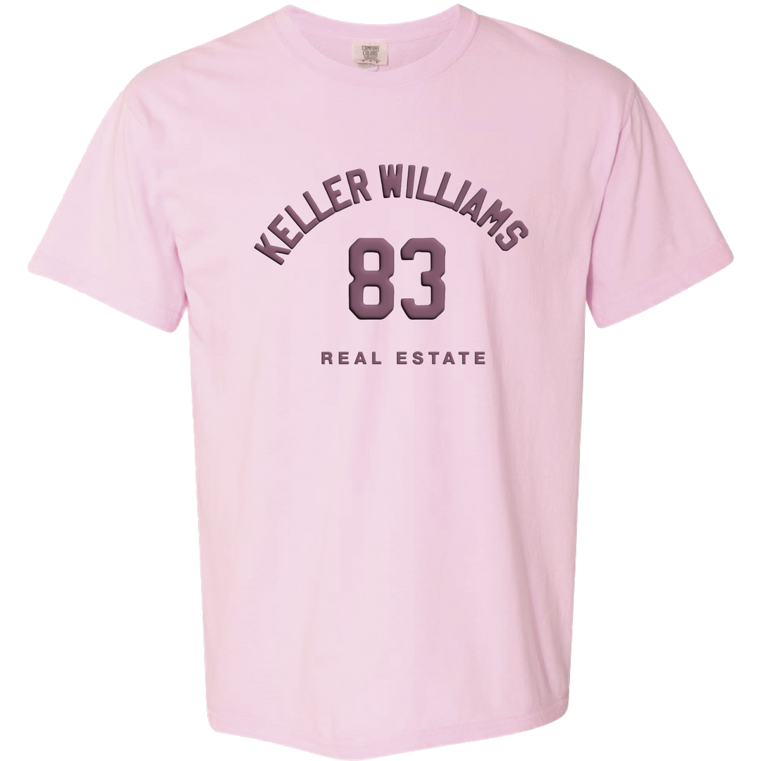 Pink t-shirt with 'Keller Williams 83 Real Estate' text on a white background