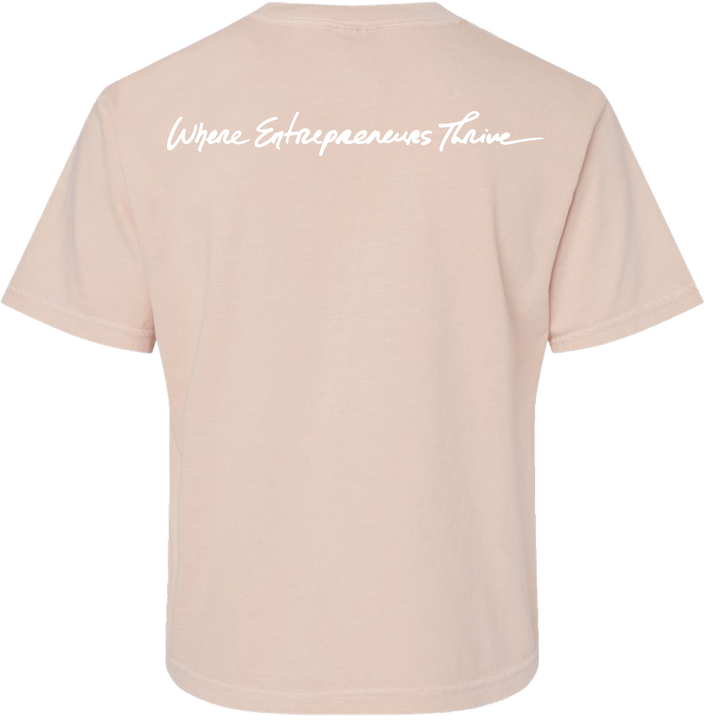 Peach t-shirt with text 'Where Entrepreneurs Thrive' on a white background