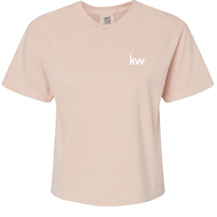 Pink t-shirt with 'kw' logo on a white background