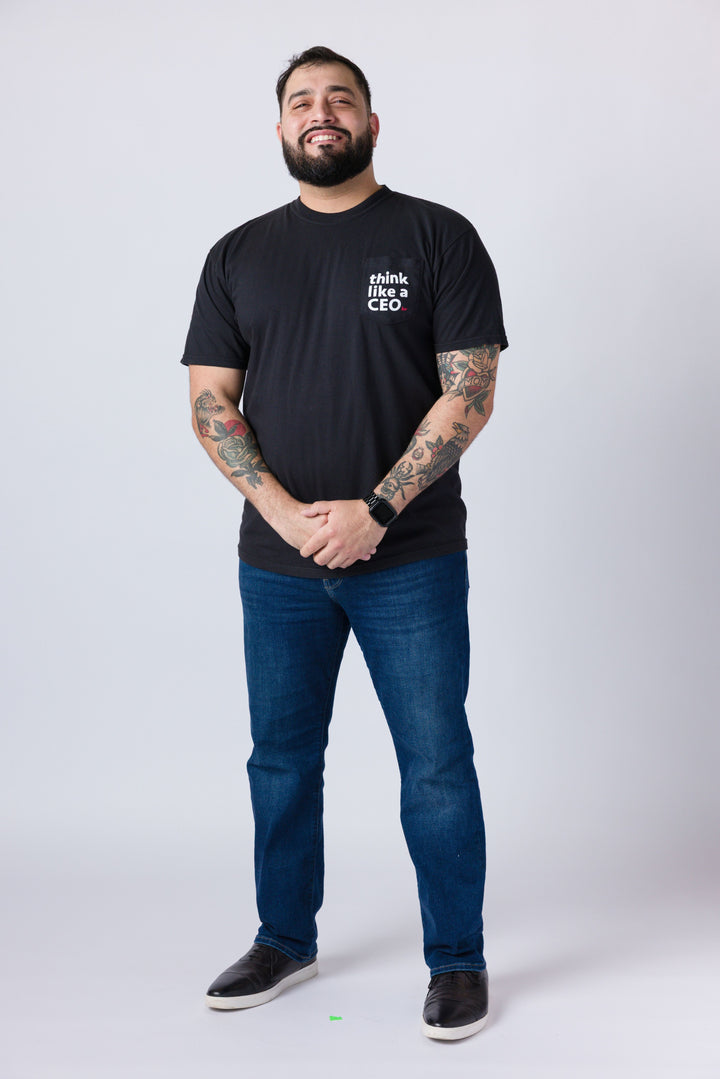Man wearing a black t-shirt with 'think like a CEO' text and blue jeans on a white background