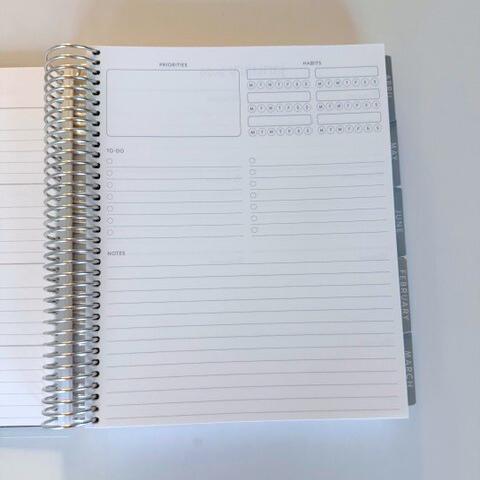Spiral-bound notebook with lined pages on a white background