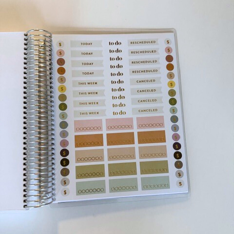 Sticker book with various labels and patterns on a white surface