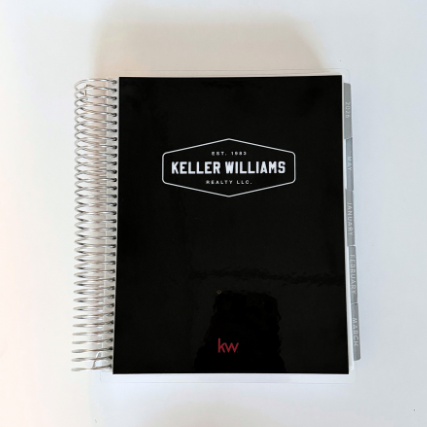 Black notebook with Keller Williams logo on a white background