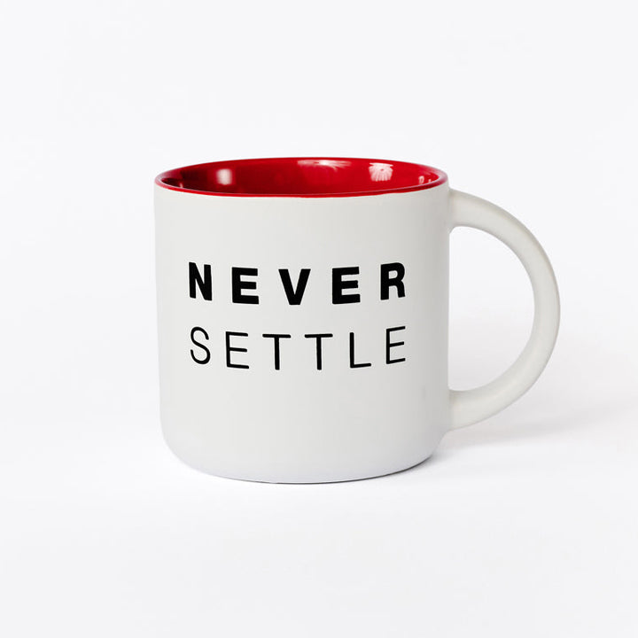 White mug with red interior and 'Never Settle' text on a white background