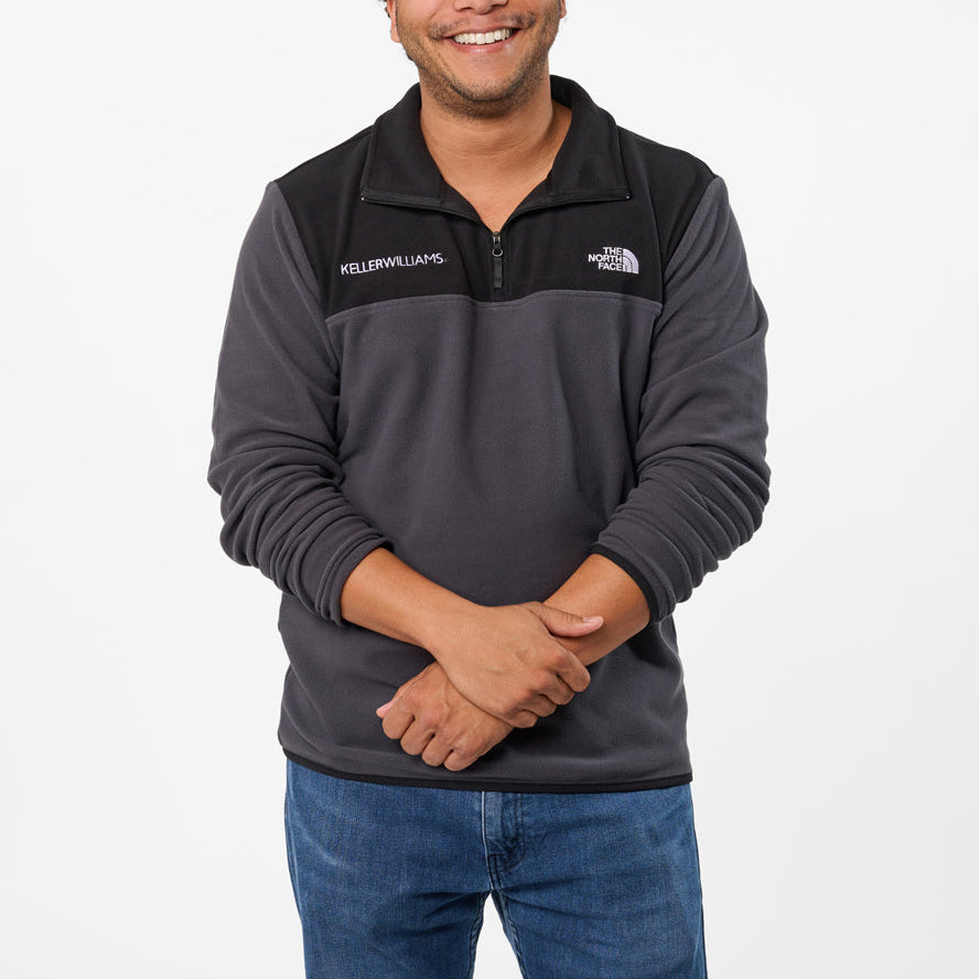 Man wearing a gray pullover with a keller williams logo on a white background