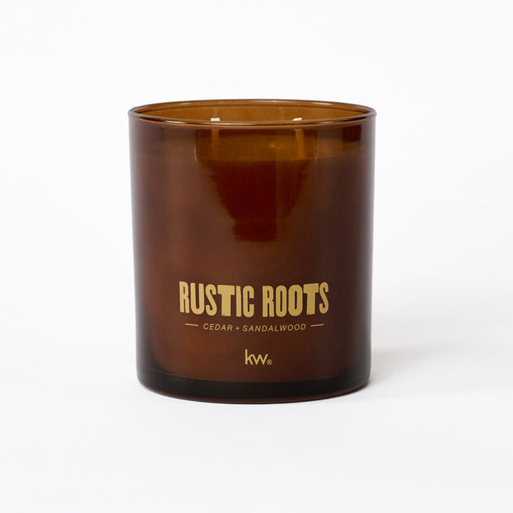 Brown candle with 'Rustic Roots' text on a white background