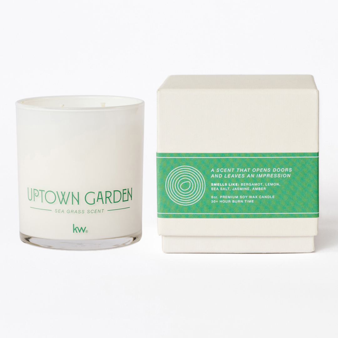 Candle labeled 'Uptown Garden' with packaging on a white background