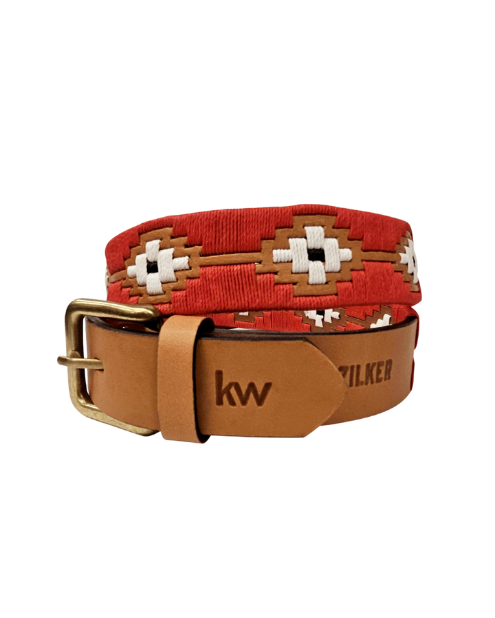 Red woven belt with a gold buckle and tan leather strap on a white background