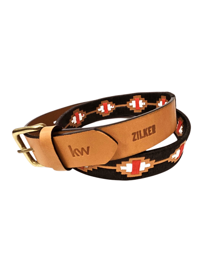Leather belt with decorative pattern and visible branding on a white background